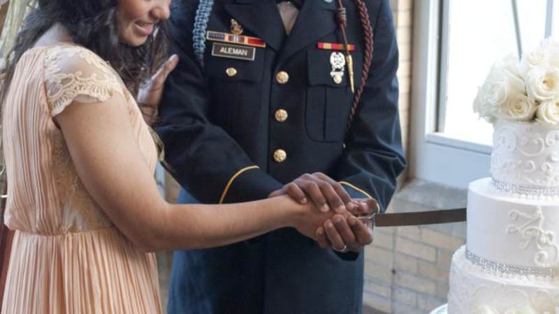 Pvt. Zoe Tunchez and Pvt. Emmanuel Aleman cut their wedding cake.