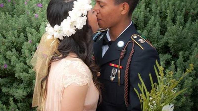 Pvt. Emmanuel Aleman kisses Pvt. Zoe Tunchez at their wedding.