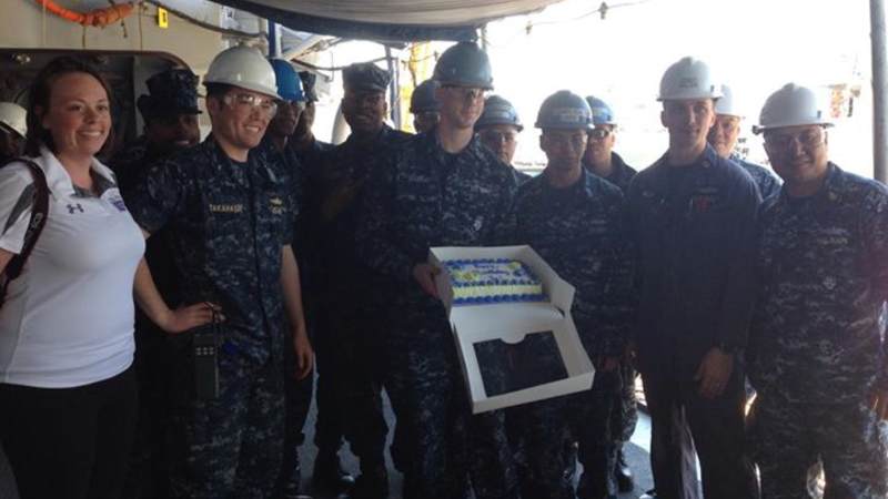 Sailors show off a birthday cake in Japan.