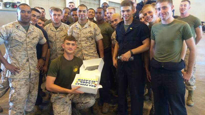 A Marine displays his birthday cake delivered by USO Okinawa.