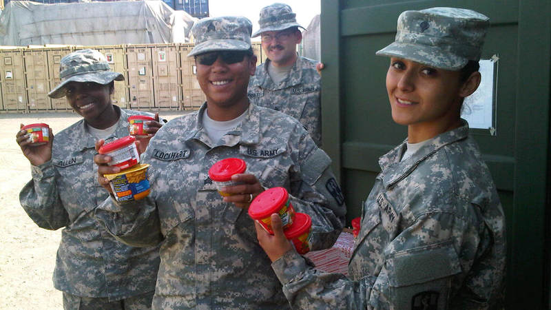 Soldiers pick up snacks donated by USO at Camp Buchanan, Liberia.