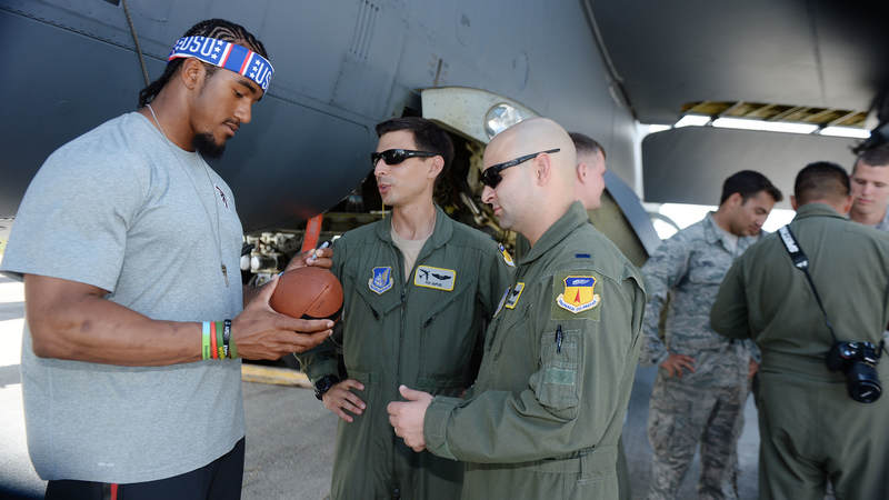 Atlanta Falcons linebacker Vic Beasley, left, signs autographs for service members during a weeklong USO/NFL tour to Guam and Hawaii.