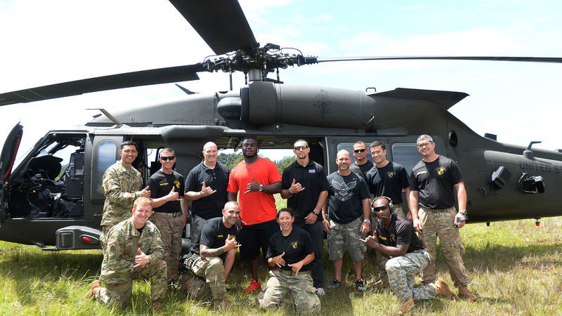 Atlanta Falcons players and head coach Dan Quinn check out an Army helicopter in Hawaii during a USO/NFL tour in June.