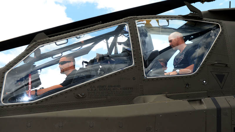 Atlanta Falcons linebacker Paul Worrilow, left and kicker Matt Bryant get an up-close look inside an Army Apache helicopter during a weeklong USO/NFL tour to Guam and Hawaii.