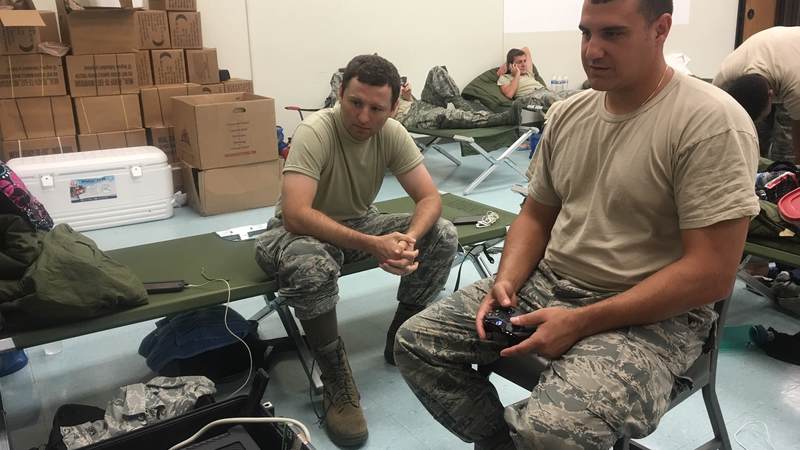Louisiana National Guardsmen enjoy playing one of 18 Mobile Entertainment Gaming Systems (MEGS) sent to service members assisting with the flood cleanup near Baton Rouge. Packaged in small, rugged containers, MEGS provides instant entertainment options to service members in remote locations. Within minutes of receiving MEGS, troops can be watching a movie or playing a video game, bringing them a true comfort from home.
