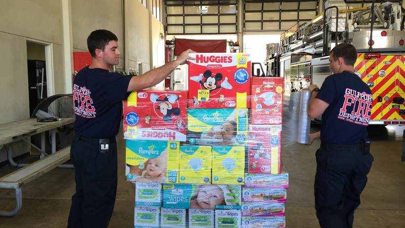 Gulfport Fire Department sorts relief supplies from the USO Gulf Coast supply drive for flood victims in Louisiana.