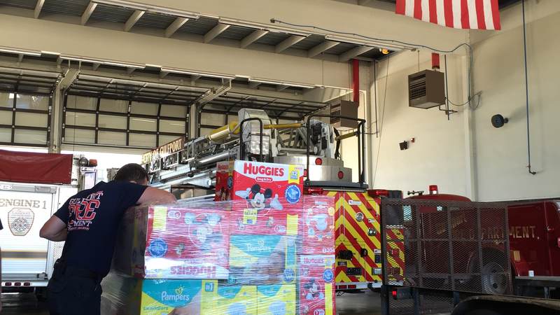 Gulfport Fire Department sorts relief supplies from the USO Gulf Coast supply drive for flood victims in Louisiana.