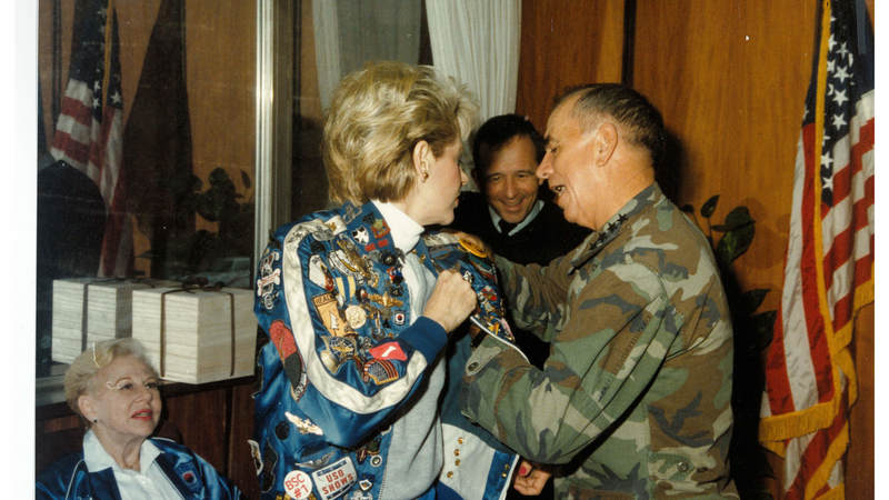 Suzanne Mitchell receives a pin.