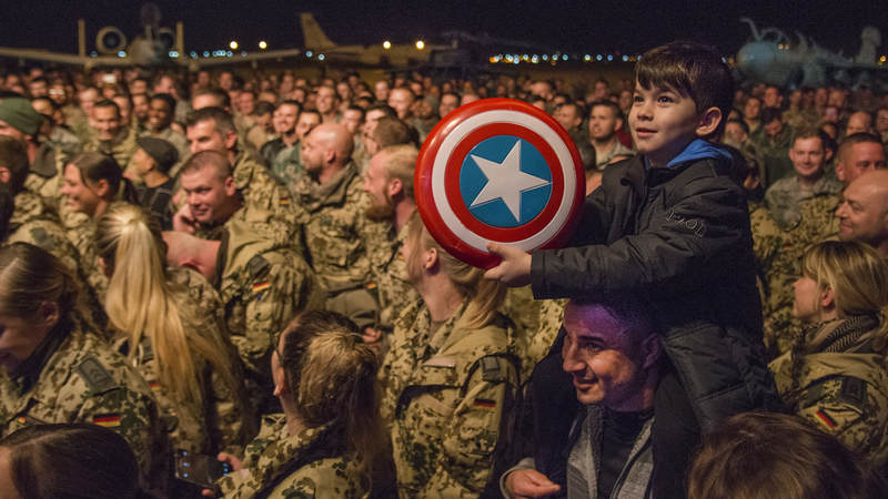 A "Captain America" fan waits for actor Chris Evans to come on stage at a USO Chairman's Holiday Tour show at Al Udeid Airbase in Qatar.