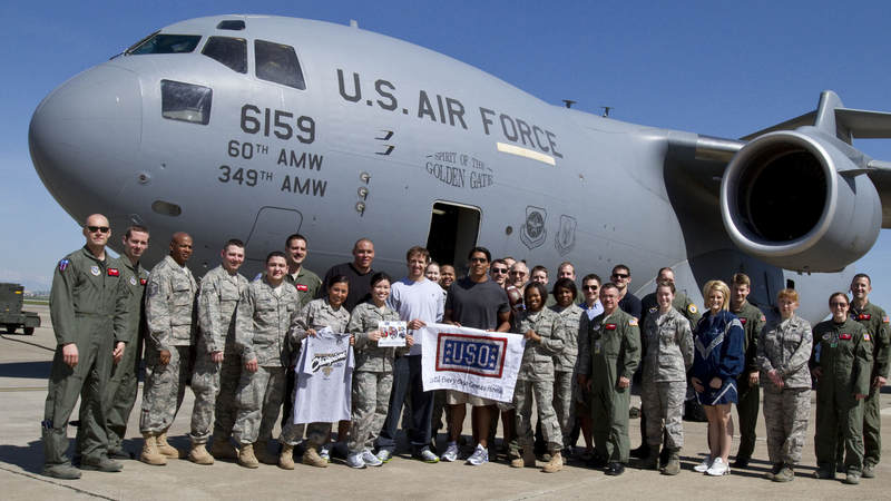 (L-R) Billy Miller, Drew Brees and Donnie Edwards pose in front of a U. S. Air Force C-17 aircraft with members of the 38th Aerial Expeditionary Group at Incirlik Air Base, Turkey, March 24, 2010. On a mission to boost morale and bring a touch of home to troops the trio recently took part in their third USO tour together.