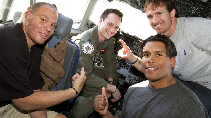(L-R) Billy Miller, Donnie Edwards and Drew Brees pose in the cockpit of a U. S. Air Force C-17 aircraft with U. S. Air Force Captain Stacey Miller of Chicago, IL. at Incirlik Air Base, Turkey, March 24, 2010.