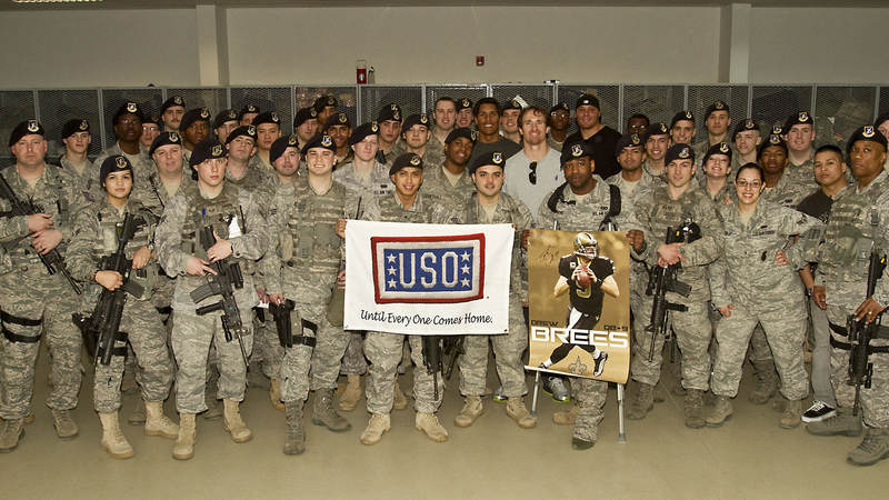 Drew Brees (center), NFL veteran Donnie Edwards (left of Brees) and Saints tight end Billy Miller (right of Brees) poses with members of the 39th Security Squadron at Incirlik Air Base, Turkey, March 24, 2010.
