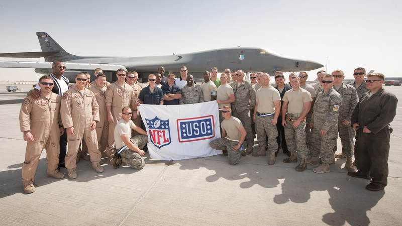 NFL players Vernon Davis-San Francisco 49ers (L), Mario Williams-Houston Texans (L-middle), Joe Thomas-Cleveland Brown (R-middle) and Jason Witten-Dallas Cowboys (R) pose for a photo with the crew of the B-i Bombers, March 3, 2010. The 2010 NFL All Stars are traveling on an eight-day, nine-base trek through the Persian Gulf on a mission to boost morale and extend their thanks to America's troops.
