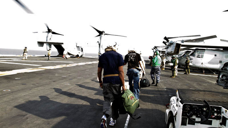 New Orleans Saints quarterback Drew Brees, former Kansas City Chiefs linebacker Donnie Edwards and New Orleans Saints tight end Billy Miller board a V-22 Osprey in route to the USS Nassau on March 29, 2010. Traveling on their third USO tour together, the NFL trio also visited troops in Turkey and Dubaii as part of their nine-day USO tour.