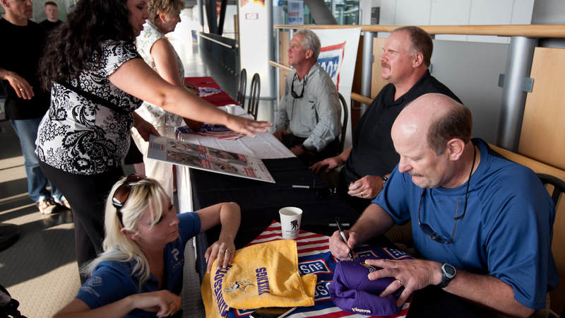 (r-l) Minnesota Vikings head coach Brad Childress, Philadelphia Eagles head coach Andy Reid and Carolina Panthers head coach John Fox sign autographs and visit with troops and their families at the USO center in the Ramstein Passenger Terminal at Ramstein Air Base in Germany, June 29, 2010.