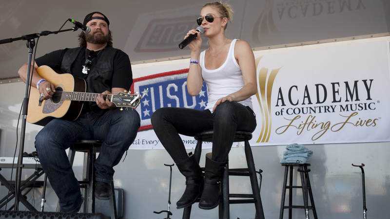 Country music artists Randy Houser and LeAnn Rimes perform together during the USO/ACM Lifting Lives concert at Nellis Air Force Base in Las Vegas on April 17, 2010.