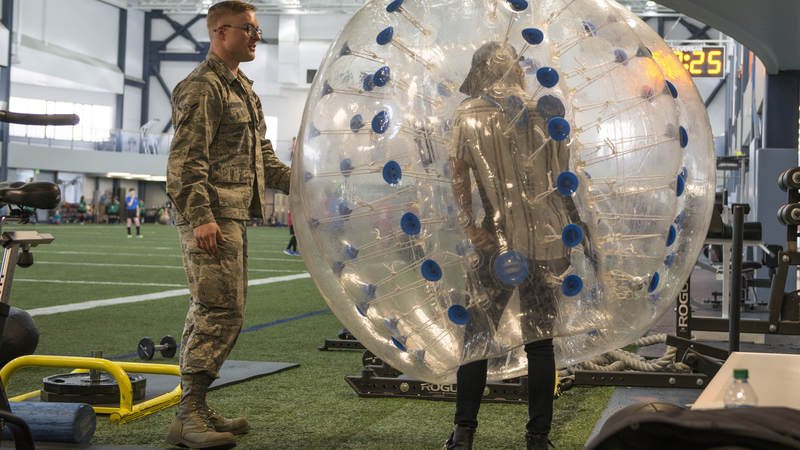 Air Force Airman Anthony Anderson, a 354th Force Support Squadron fitness specialist, explains how to use a knocker ball to Cassadee Pope April 8 at Eielson Air Force Base, Alaska.
