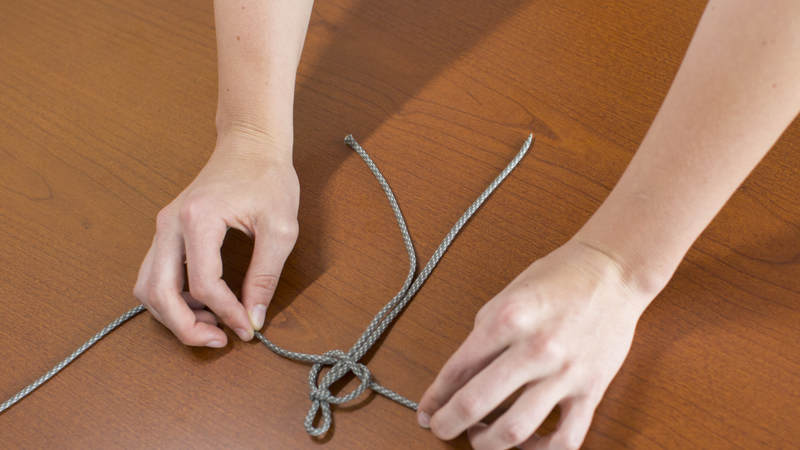7. Loop this same strand through the loop you created on the right. The knot should resemble a pretzel.