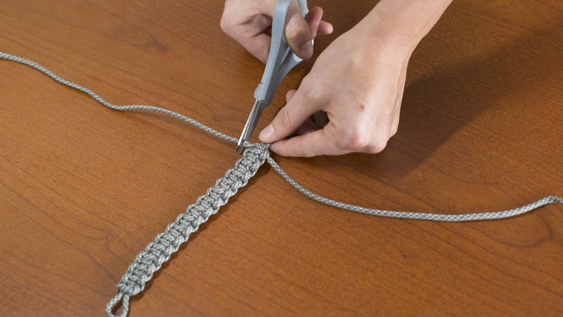 11. Repeat this alternating process until you reach the desired length of your bracelet. Cut off both long pieces of cord from your bracelet.