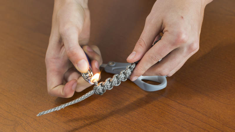 12. Using a lighter, melt both of cut ends to secure the braid you just crafted.