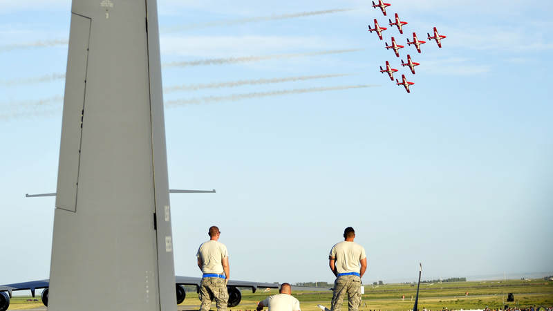 U.S. airmen watch the Royal Canadian Forces Snowbirds perform in Lethbridge, Alberta, Canada.