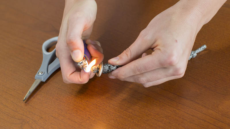 16. Using a lighter, melt the ends of the knot together to avoid any unraveling.