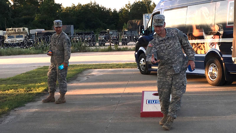 Service members play corn hole provided by the Mobile USO team at Fort Swift, the staging location for much of the military's Harvey relief efforts.