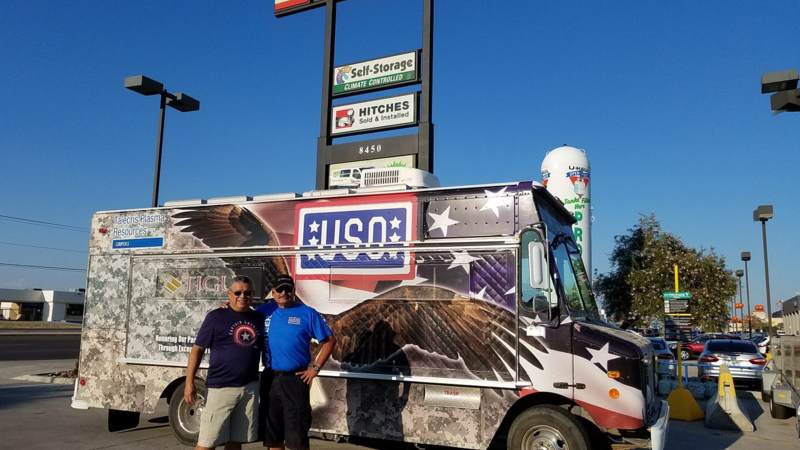 Volunteers smile in front of the USO El Paso Mobile unit, which will head to the Houston area to provide refreshments to service members supporting Harvey relief efforts.