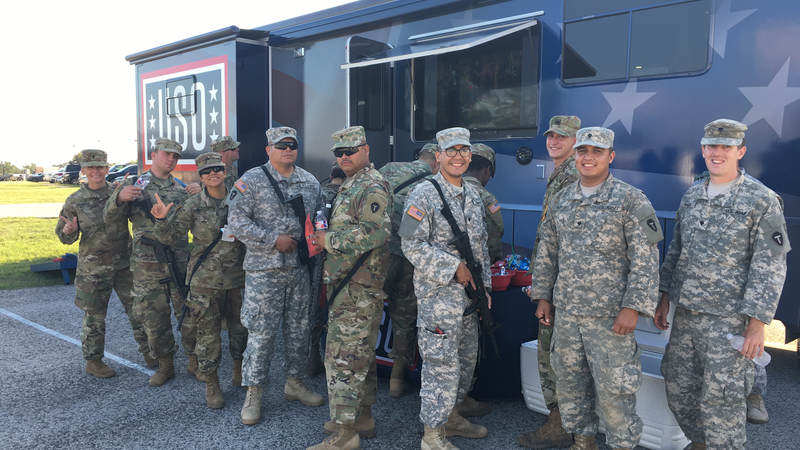 Service members smile outside the USO Mobile unit at Fort Swift, the staging location for much of the military's Harvey relief efforts.