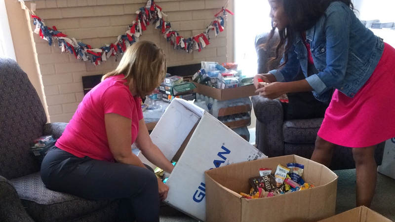 The Greater Jacksonville Florida Area USO team preps care package supplies to hand out to service members supporting Hurricane Irma relief efforts.