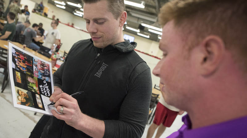 WWE Superstar The Miz signs an autograph for a service member at the base dining facility during the Chairman’s USO Holiday Tour at Al Dhafra Air Base Dec. 22.