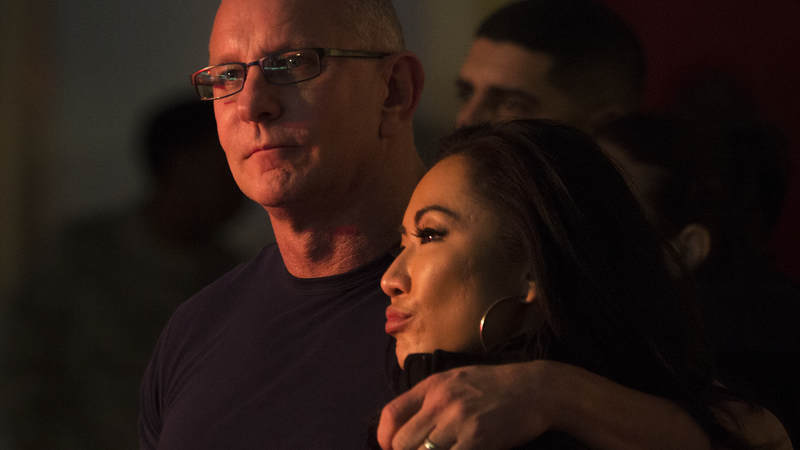 Chef Robert Irvine and his wife, Gail Kim, watch country music artist Jerrod Niemann perform during Chairman’s USO Holiday Tour at Morón Air Base Dec. 21.