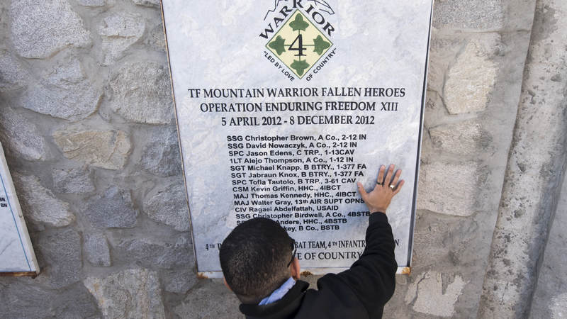 Medal of Honor recipient, retired Army Capt. Florent Groberg pays tribute to those who were killed in action at a memorial while visiting Operating Base Fenty, Afghanistan.
