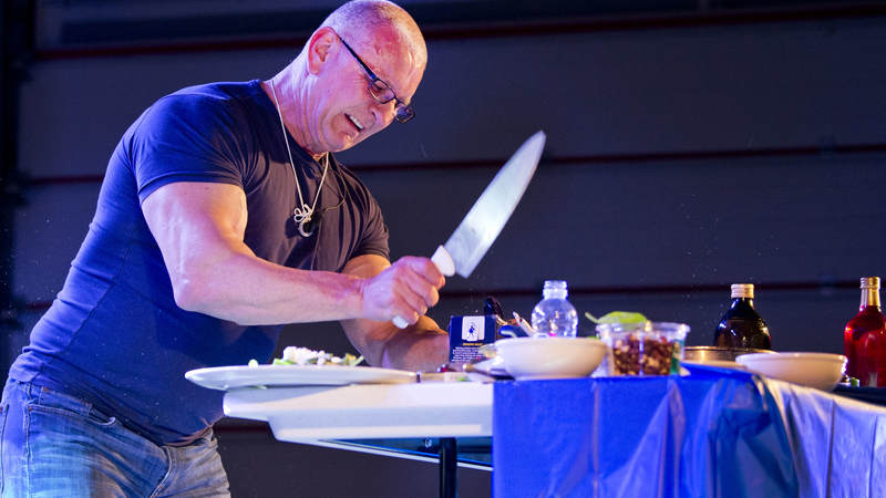 Chef and TV host Robert Irvine hosts a cooking demonstration during during the USO Holiday Tour at Al Dhafra Air Base.