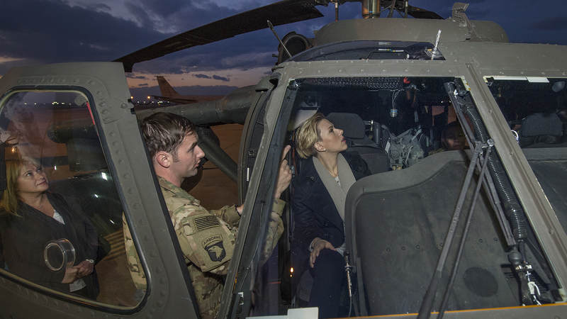 A pilot explains the controls of a Blackhawk helicopter to Scarlett Johansson during the trip to Incirlik Air Base, Turkey.