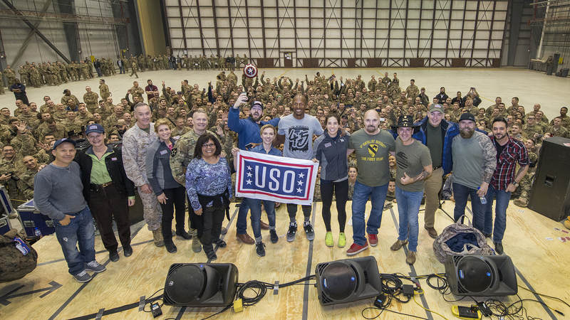 Johansson and other tour participants pose for a quick group photo in front of service members at Bagram Air Base in Afghanistan.