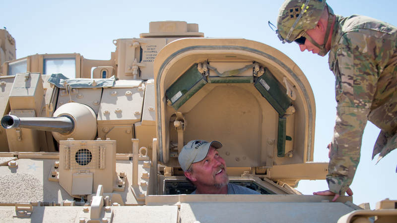 Adkins checks out the inside of a tank at Camp Buehring, Kuwait, during a USO tour to the Middle East.