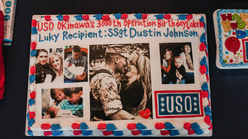 Marine Staff Sgt. Dustin Johnson's birthday cake was one-of-a-kind, thanks to his wife, Melanie, who supplied the photos. USO photo by Amber Craig.