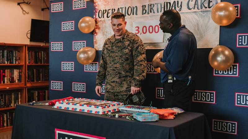 Marine Staff Sgt. Dustin Johnson, who's deployed to Okinawa, Japan, turned 29 earlier this week. He thought he was invited to lunch at USO Camp Hansen and had no idea he was showing up to his own birthday party. USO photo by Amber Craig.