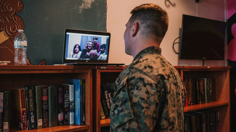 Marine Staff Sgt. Dustin Johnson, who's deployed to Okinawa, Japan, talks to his family in North Carolina over Skype during his surprise birthday celebration. USO photo by Amber Craig.