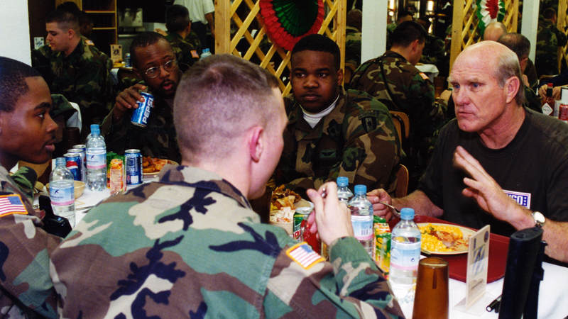 Pittsburgh Steelers football great Terry Bradshaw talks with troops during his visit to Tuzla Air Base, Bosnia, in 2000.