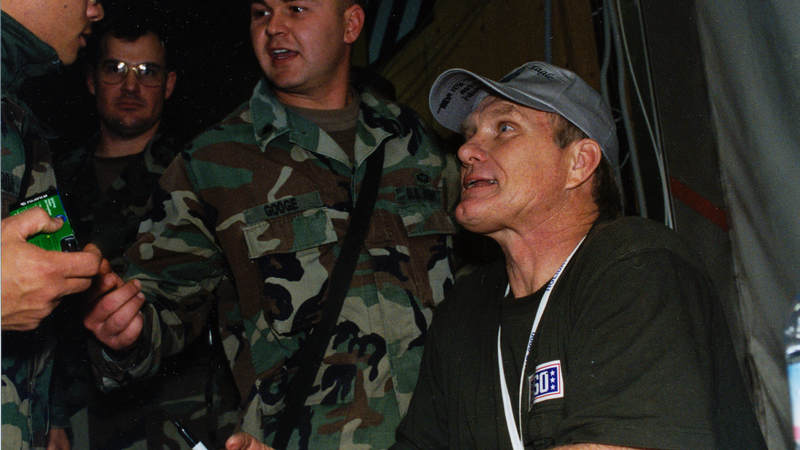 Pittsburgh Steelers football great Terry Bradshaw talks with troops during his visit to Tuzla Air Base, Bosnia, in 2000.
