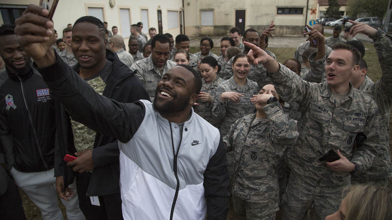 New Orleans saints running back Mark Ingram takes a selfie with troops at Aviano Air Base in Italy during the 2018 USO-NFL tour.
