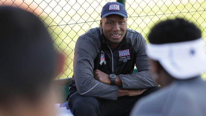 Cincinnati Bengals defensive end Carlos Dunlap listens during a question-and-answer session with high school football players in Germany.