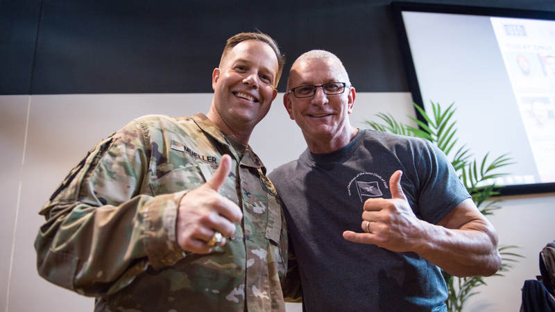 Celebrity chef and TV host Robert Irvine poses for a photo with a service member. Army photo by Sgt. James McCann