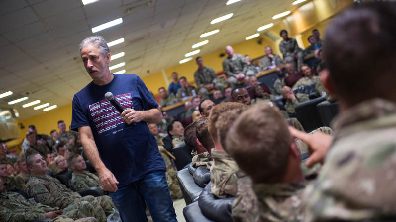 Former "Daily Show" host Jon Stewart performs for troops during the USO Spring Tour in April. Army photo by Sgt. James McCann