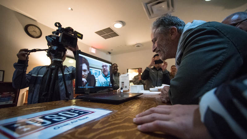 Former "Daily Show" host Jon Stewart talks to parents of a service member during an Operation Birthday Cake at a USO center in South Korea. Army photo by Sgt. James McCann