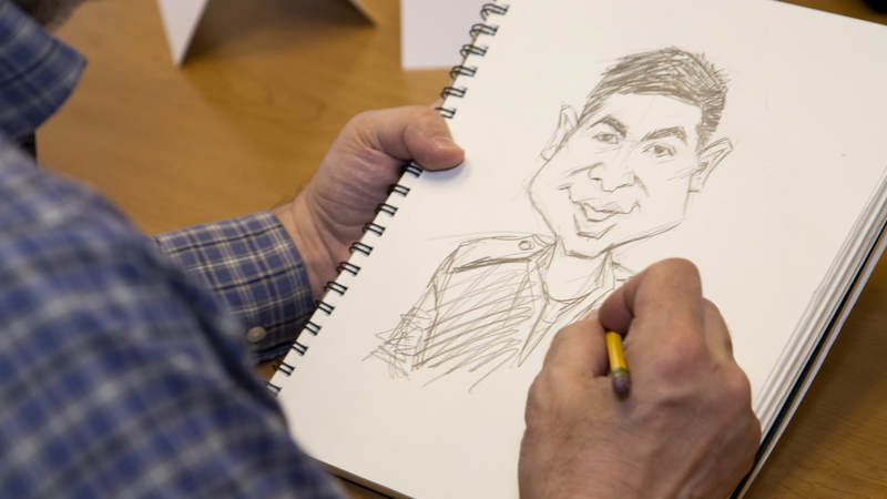 A classic Sam Viviano caricature done for a Navy Corpsman serving at the Naval Heath Clinic New England. USO Photo by Joseph Andrew Lee