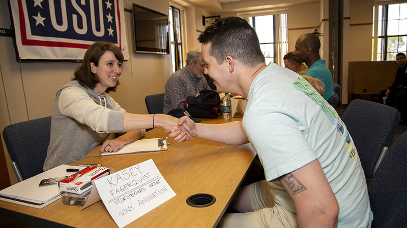 Sony Pictures Animation story artist Kasey Fagerquist, new to the USO National Cartoonists Society tour, drew dozens of original works for service members over the two-day tour of the northeast. USO Photo by Joseph Andrew Lee