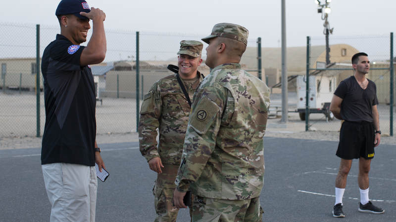 Kevin Martin smiles while talking with service members.